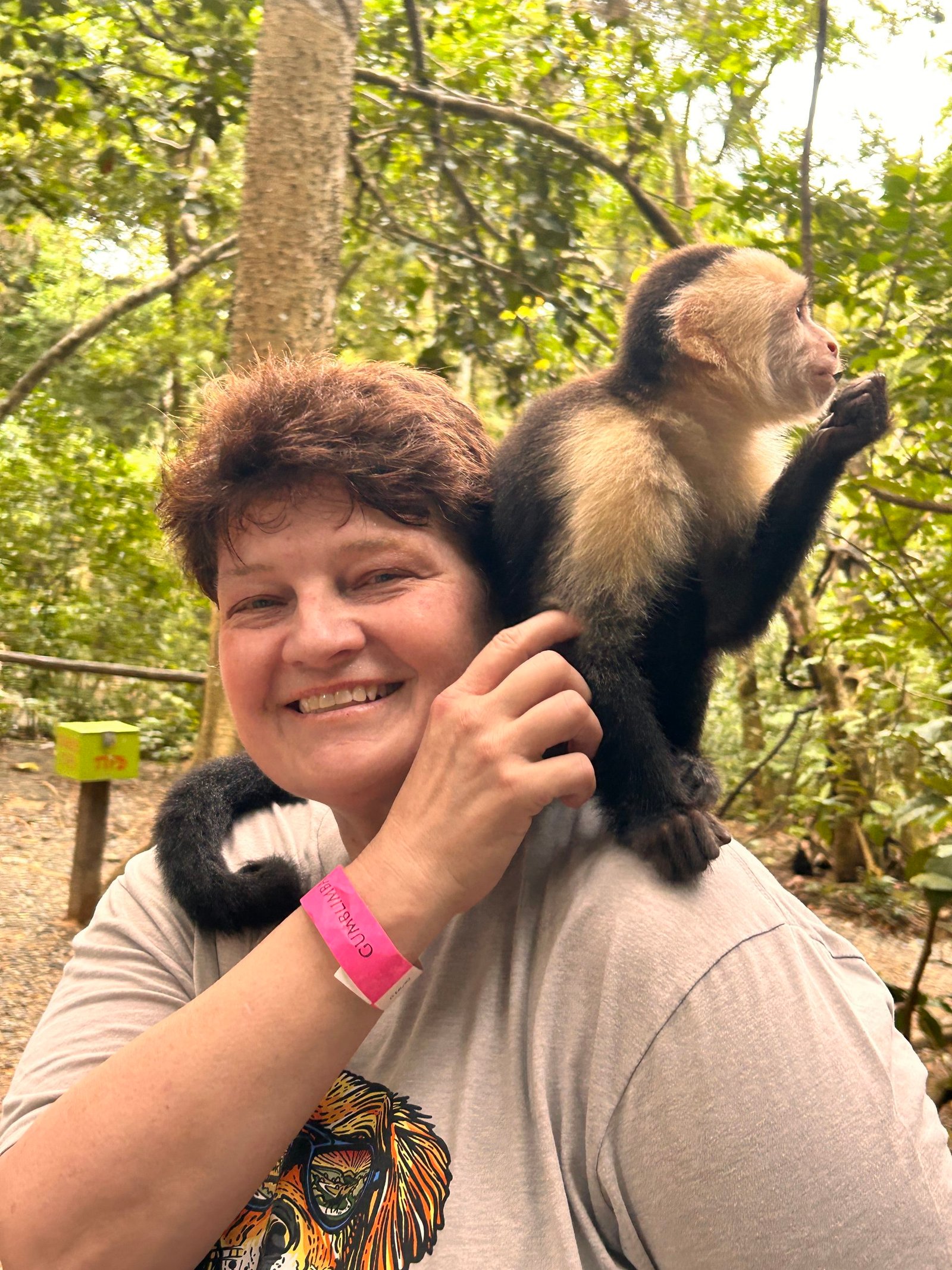 Angela Addington with a monkey on her shoulder during a wildlife sanctuary tour in Roatan, Honduras