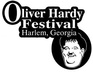 Black and white logo for the Oliver Hardy Festival in Harlem, Georgia, featuring bold text and a cartoon-style illustration of Oliver Hardy’s smiling face inside a circular frame.