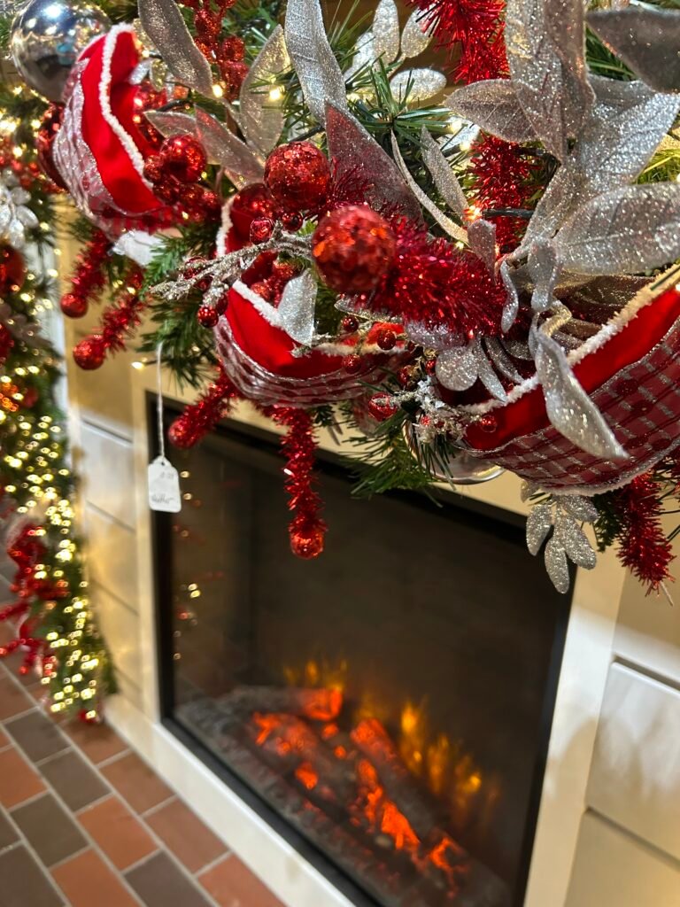 Festively decorated fireplace display inside The Incredible Christmas Place in Pigeon Forge