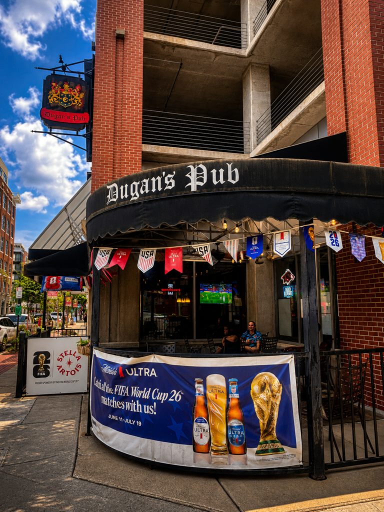 Dugan's Pub in downtown Wichita, Kansas, with its outdoor patio, historic hanging sign, and FIFA World Cup banners decorating the entrance.