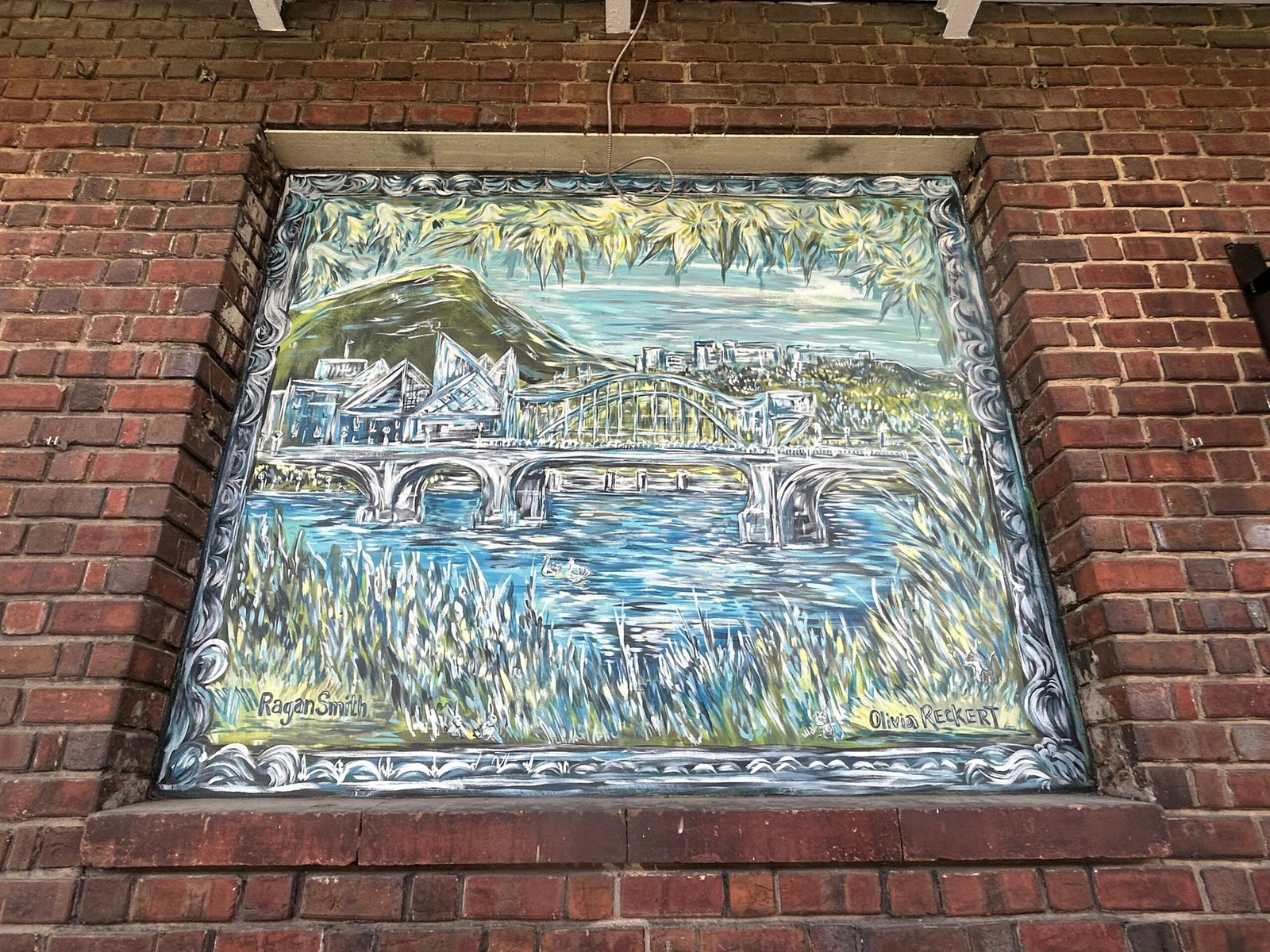 Painted Chattanooga landscape featuring the Tennessee River, bridges, mountain and city skyline, signed by Ragan Smith and Olivia Reckert.