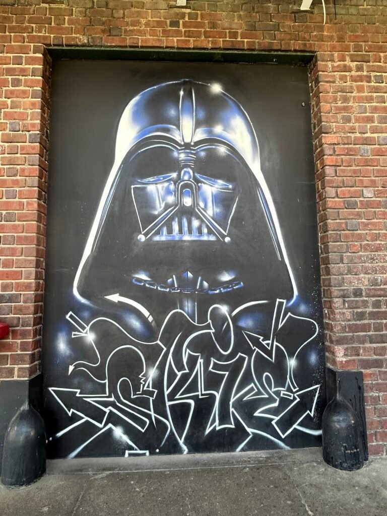 Darth Vader helmet above bold white graffiti lettering on a black doorway at the Chattanooga Choo Choo.