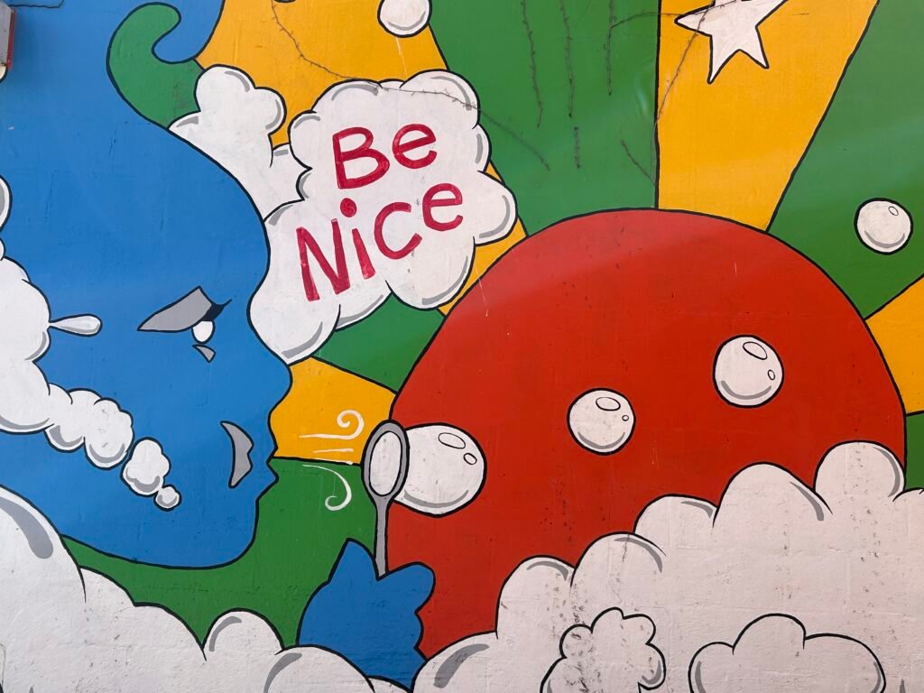 Close-up of the Be Nice message on a colorful Chattanooga street art mural