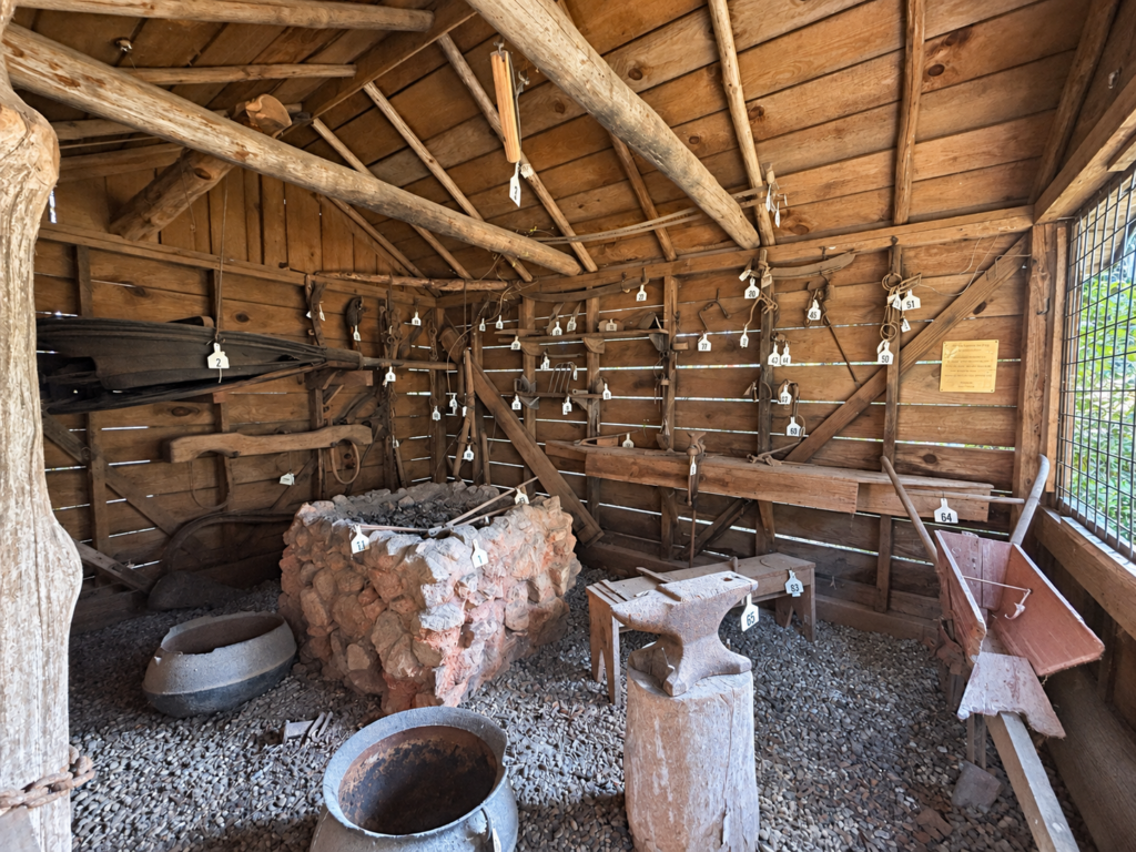 Historic blacksmith exhibit with an anvil and antique tools in Turner Park in Eatonton