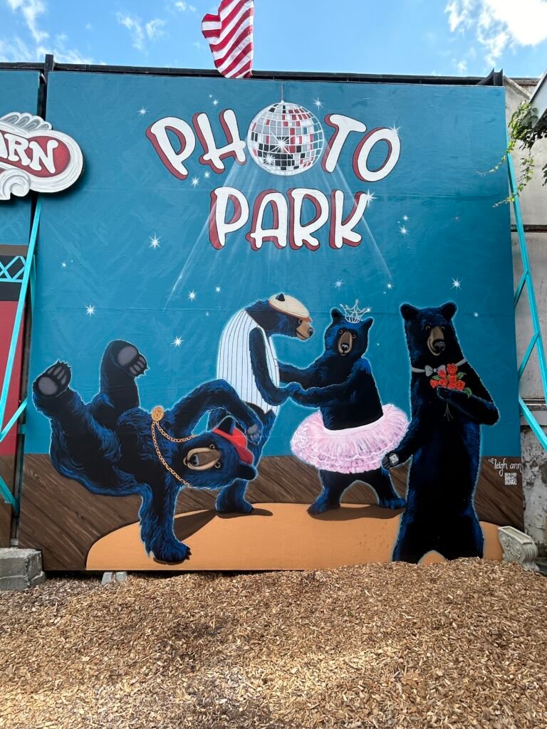 Playful black bears dancing beneath the Photo Park sign at Bigfoot’s Country Barn.