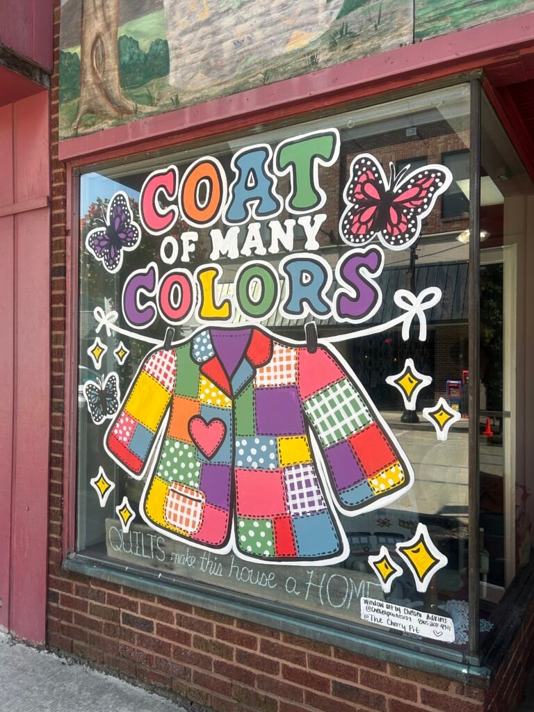 Painted Coat of Many Colors window with a patchwork coat and butterflies in downtown Sevierville