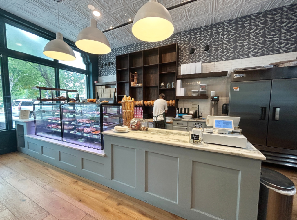 Interior of The Patisserie on Main with pastry cases, artisan bread and blue counters