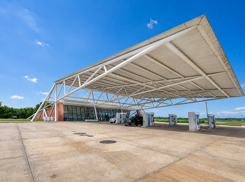 Wide white canopy covering the fuel pumps outside the modern POPS 66 building in Arcadia, Oklahoma.