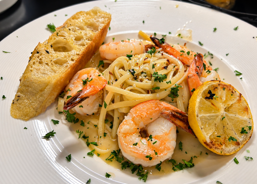 Close-up of shrimp scampi with jumbo shrimp, linguine and grilled lemon at Italian Chophouse