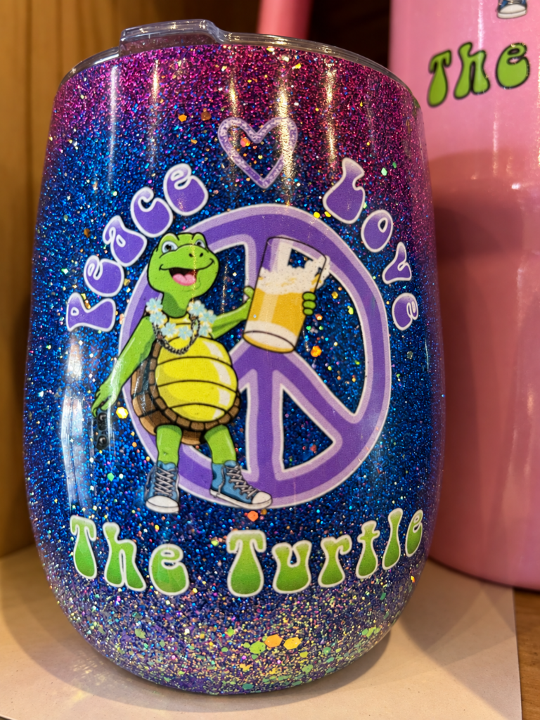 Colorful Peace Love The Turtle glitter tumbler displayed inside the Eatonton restaurant