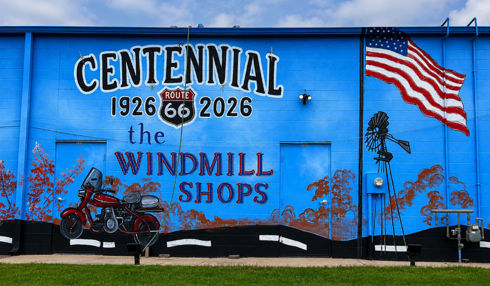 Route 66 Centennial mural panel at the Windmill Shops in Arcadia, Oklahoma, featuring a motorcycle, American flag and windmill.