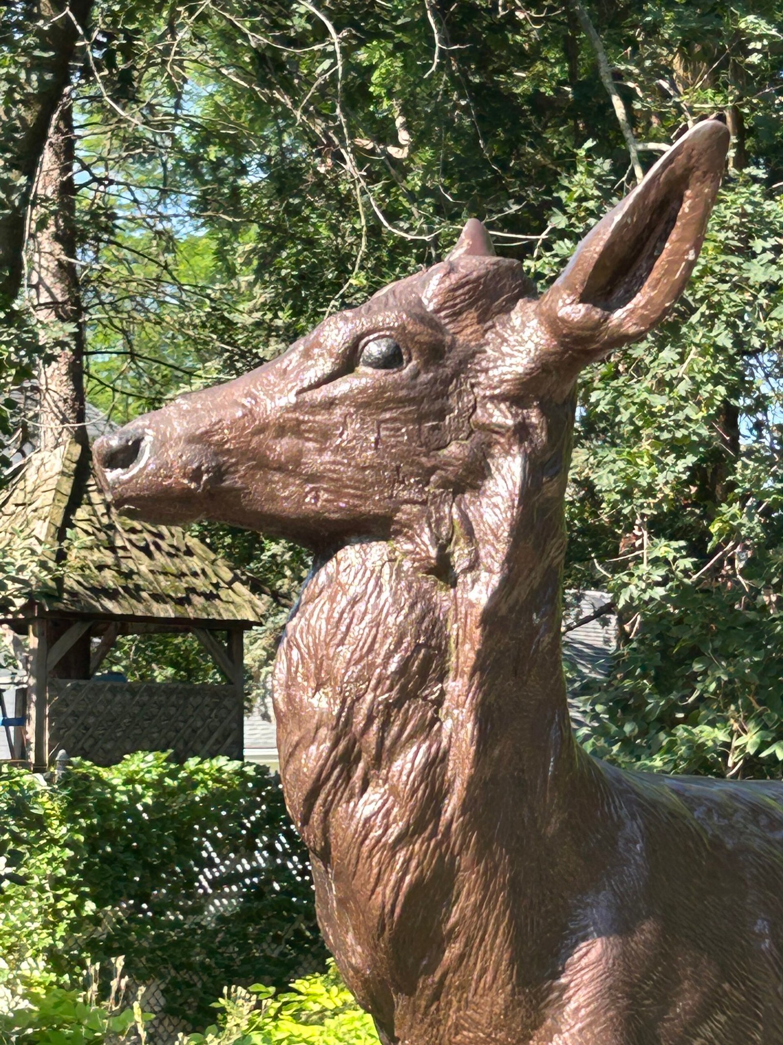 Bronze deer sculpture among landscaping at Lilacia Park in Lombard Illinois