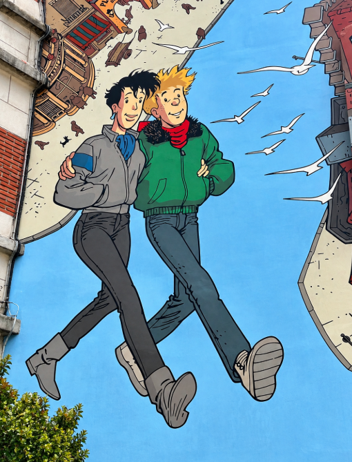 Brussels comic strip mural depicting two illustrated characters walking together against a blue background