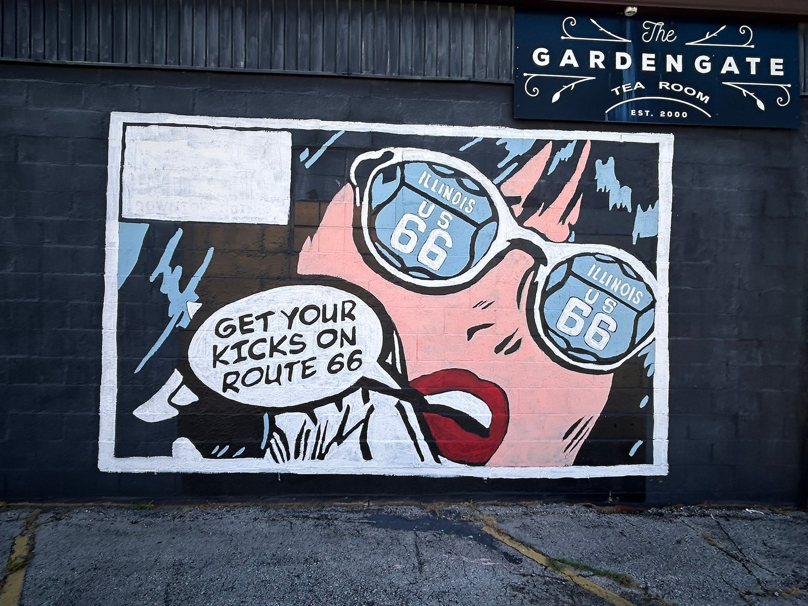 Get Your Kicks on Route 66 mural in Granite City, Illinois, featuring a stylized face with Route 66 sunglasses and a speech bubble