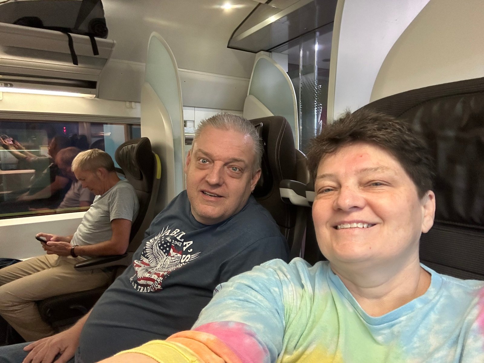 Two travelers seated together inside a Eurostar passenger carriage