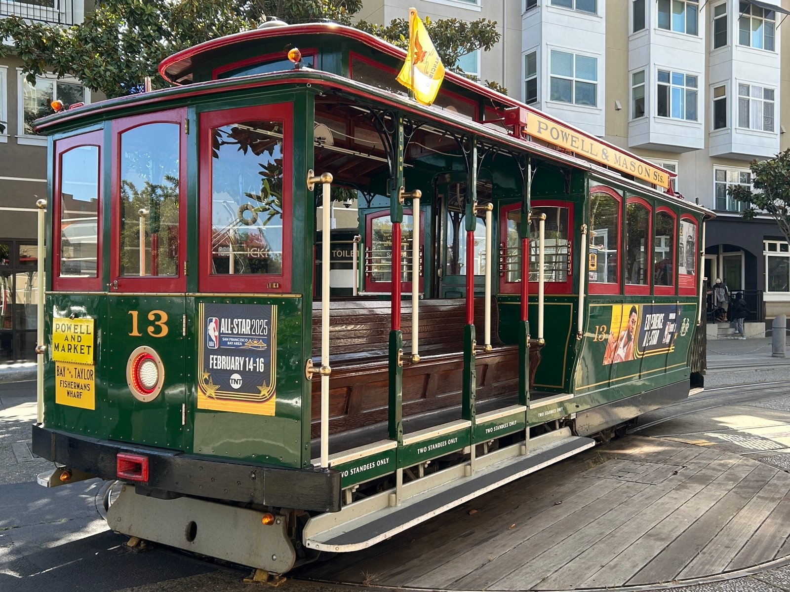 Historic Powell and Mason cable car in San Francisco showing the open-air side seating and route sign